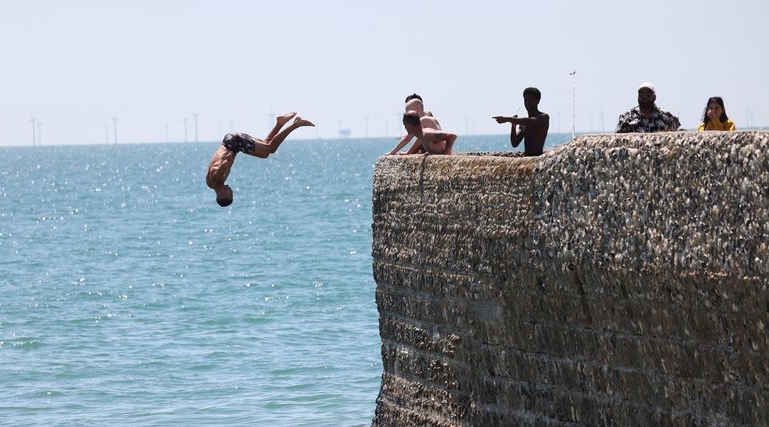 Men jumping into wild water